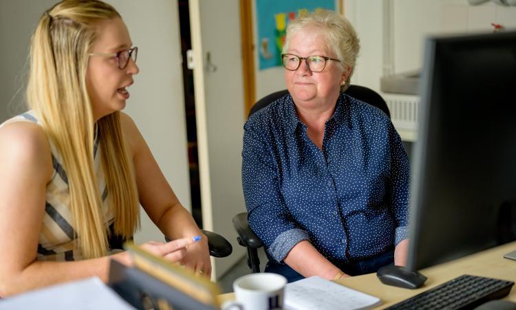 Two women talking at work