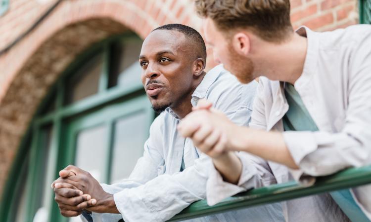 Two guys having a conversation outside