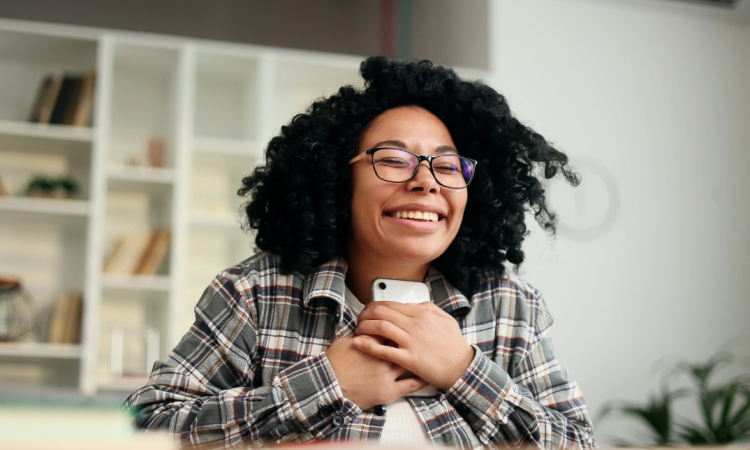 Person holding phone smiling