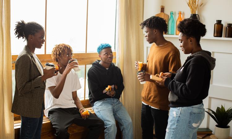 A group of people sitting and standing together