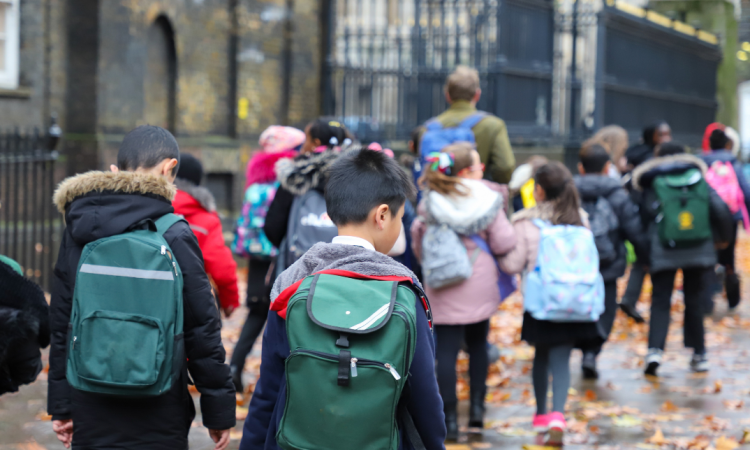 Children walking with school backpacks on