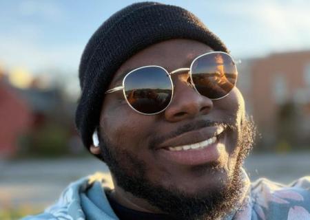 man smiles into sunshine