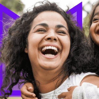 Adult and young person laughing together