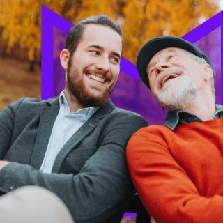 Two people on park bench smiling