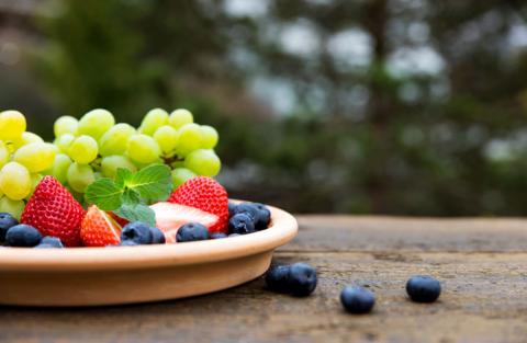 Bowl of fruit on a table outside