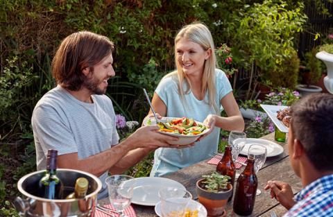Three people sharing a meal together outside