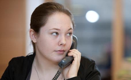 A young woman on an office phone