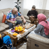 Family playing a game of chess in living room