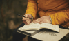 Photo of a person writing in a journal